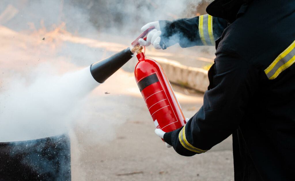 Blog 5 a firefighter using a fire extinguisher